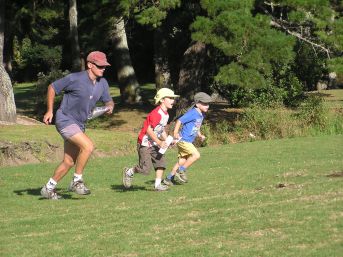 Family running across field