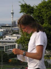 Lady looking at map with Auckland Sky Tower in
          background